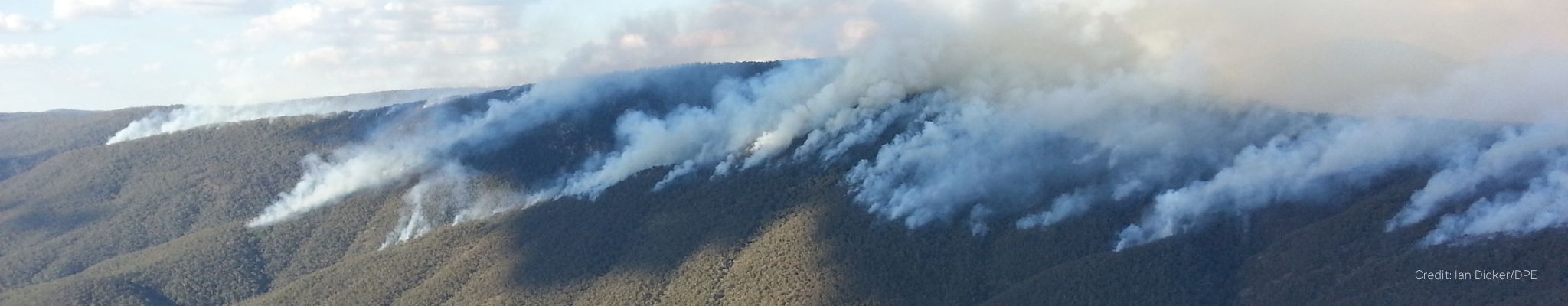 Smoke from a bushfire drifts across ranges