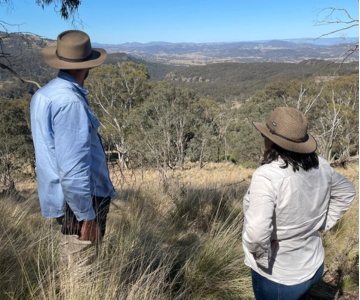 Upper Under tender thumbnail A man and woman stand on a hill looking at a valley view