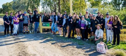 Conservation Champions students from Hay High School at Gayini Nimmie Caira in the Riverina region A group of high school aged students stand with educators at the gate to the Gayini property